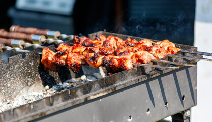 A grill with meat on it and a lot of smoke