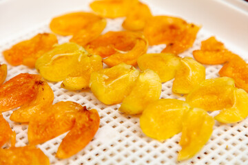 A close-up of dried fruits, including several dried apricots.
