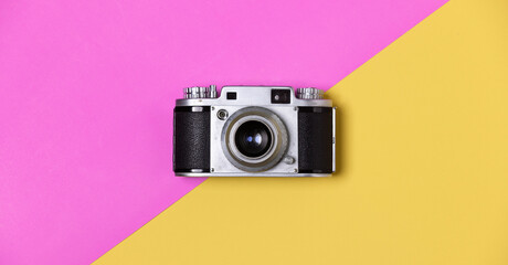 Flat lay, vintage film camera on pastel background, photography minimal idea.