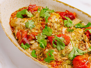 Delicious baked chicken dish with fresh herbs and vegetables
