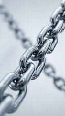 Fototapeta premium Close-up of a gleaming metal chain, showcasing intricate detail and a strong industrial vibe.