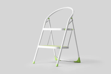Green stepladder on light background