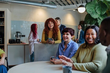 Diverse business team enjoying coffee break in modern office