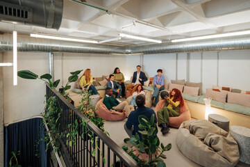 Fototapeta na wymiar Creative team building activities with bean bags and a basketball in modern office