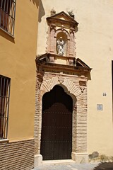 Historic Religious Facade with Statue in Andalusian City, Spain