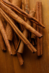 Cinnamon sticks dried tree bark spice on rustic wooden table background.