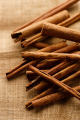 Cinnamon sticks dried tree bark spice on rustic background.