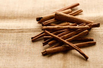 Cinnamon sticks dried tree bark spice on rustic background.
