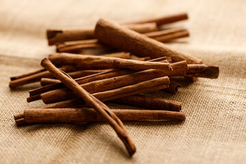 Cinnamon sticks dried tree bark spice on rustic background.