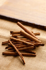 Cinnamon sticks dried tree bark spice on rustic background.