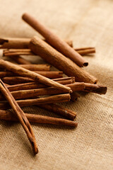 Cinnamon sticks dried tree bark spice on rustic background.