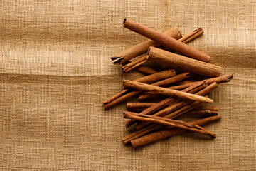Cinnamon sticks dried tree bark spice on rustic background.