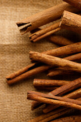 Cinnamon sticks dried tree bark spice on rustic background.