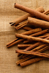 Cinnamon sticks dried tree bark spice on rustic background.