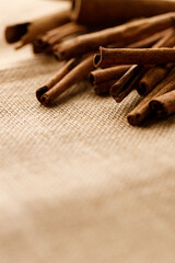 Cinnamon sticks dried tree bark spice on rustic background.