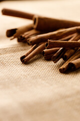Cinnamon sticks dried tree bark spice on rustic background.