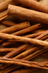 Cinnamon sticks dried tree bark spice on rustic background.