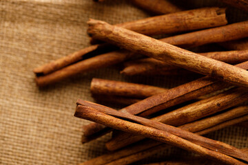 Cinnamon sticks dried tree bark spice on rustic background.