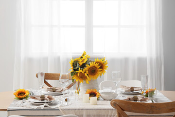Elegant table serving with plates, glasses and beautiful sunflowers
