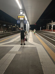 Adult man looks at train timetables with respective delays