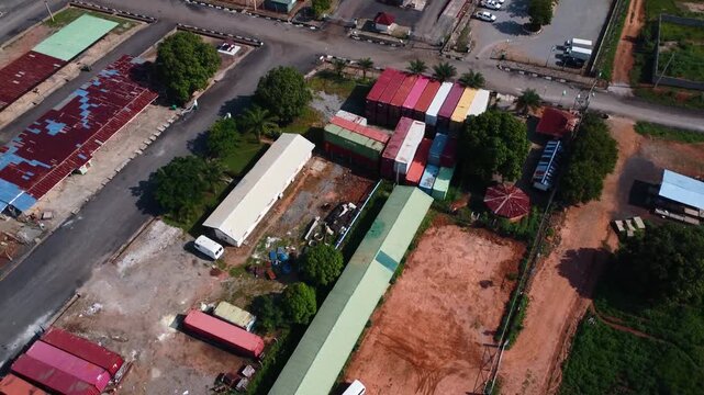 Drone rises above SCC site with colorful containers, warehouses and open yard