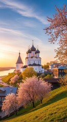 Fototapeta premium Picturesque orthodox church and cherry blossoms at dawn in Suzdal Russia