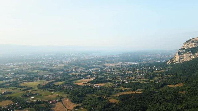 Pull out drone shot of Saleve, canton of Geneva and Lake of Geneva at sunset from France