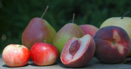 Pears, peaches and apples on the board
