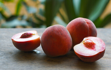 Red peaches are scattered on the table.