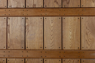 Weathered gray wooden panels with small nails. Vertical timber planks showing natural grain, patina, and texture, reflecting rustic Nordic craftsmanship
