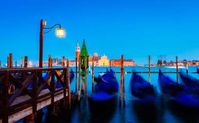 Blured Gondolas motion in the Grand Canal at night, Venice, Italy © neirfy