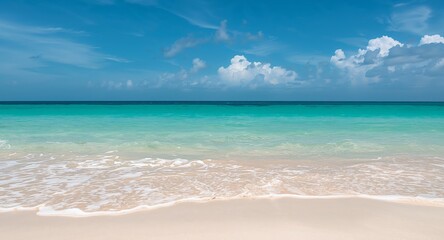 Obraz premium Serene Tropical Beach Scene with Turquoise Water and Clear Blue Sky, Waves Rolling In.