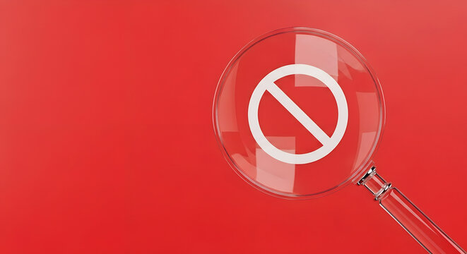Magnifying glass focusing on a prohibition sign against a vibrant red background