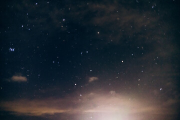 The captivating night sky filled with countless stars and wispy clouds, creating a magical and serene astronomical scene.