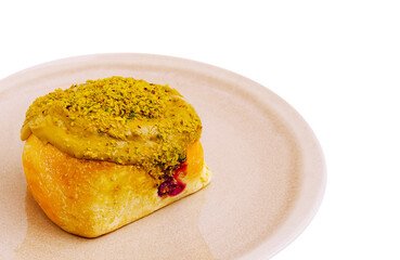 Delicious pastry topped with pistachio and sweet filling on a plate