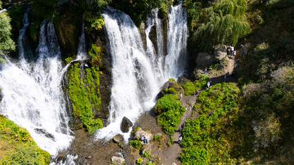Aerial view of a beautiful waterfall cascading down rocky cliffs
