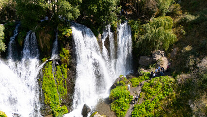 Aerial view of a beautiful waterfall cascading down rocky cliffs