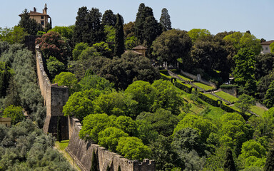 Scenic view of Forte di Belvedere and walls atop a hill, encircled by greenery and trees, down the hillside, blending architecture with picturesque landscape. Medici district of Florence, Italy.