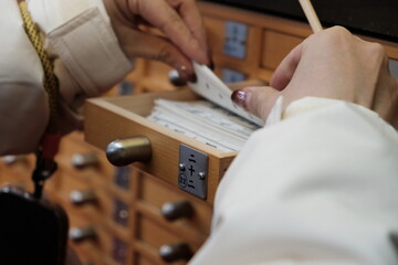Draw a fortune slip "Omikuji" in Asakusa Kannon, Japanese Buddhist Temple