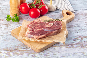 Raw lamb steak with bone