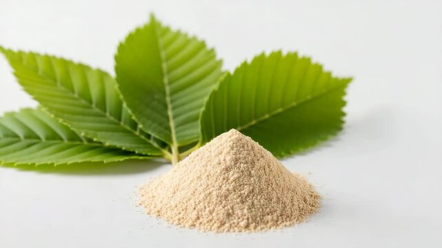 Natural Pile of slippery elm powder with green leaves on soft white background  