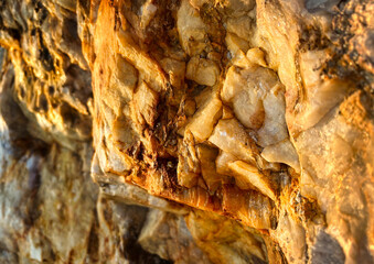 Close-up with shallow depth of field of quartz mineral with iron veins, with lots of texture and warm tones.