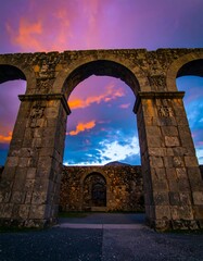 Fototapeta premium Ancient Roman aqueduct arches at sunset