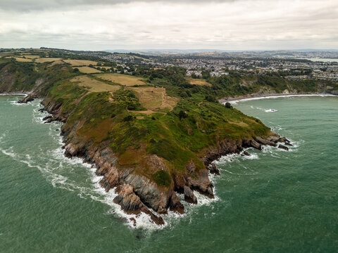 Rocky coast meeting green sea in County Cork, Ireland - Powered by Adobe