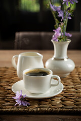 Freshly brewed coffee served elegantly with flowers in a cozy indoor setting