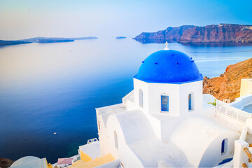 traditional greek village Oia of Santorini, with blue domes of churches and village roofs, Greece