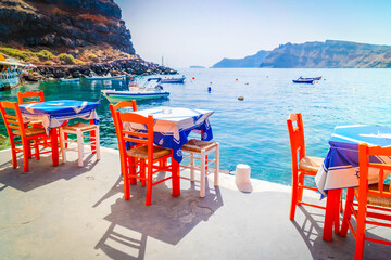 chairs and dinner table with view of caldera, Santorini, Greece