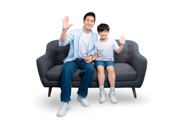 Obraz premium A father and son waving hands, seated on a sofa with bright background