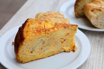 Tapas small Spanish dish. Spanish cuisine in Alicante. Portion of tortilla de patatas.