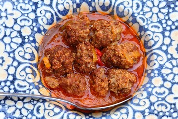 Tapas small Spanish dish. Spanish cuisine in Alicante. Portion of albondigas meatballs.